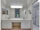 Bathroom with double vanity and a large mirror above at 746 Masterpiece Dr, Sun City Center, FL 33573