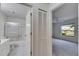Bathroom view to shower, toilet and bedroom at 746 Masterpiece Dr, Sun City Center, FL 33573