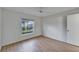 Cozy bedroom features a ceiling fan, neutral walls, wood-look floors, and a window with pleasant views at 746 Masterpiece Dr, Sun City Center, FL 33573