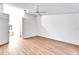 Bright bedroom with light wood floors, ceiling fan, and ensuite bath at 746 Masterpiece Dr, Sun City Center, FL 33573