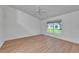 Spacious bedroom with light wood floors, a ceiling fan, and a bright window at 746 Masterpiece Dr, Sun City Center, FL 33573