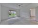Large bedroom features a ceiling fan, carpet, and view to the outside at 746 Masterpiece Dr, Sun City Center, FL 33573