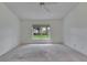 Spacious bedroom with ceiling fan, carpet, and a large window overlooking the backyard at 746 Masterpiece Dr, Sun City Center, FL 33573