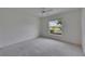 Bedroom featuring a large window with neighborhood views at 746 Masterpiece Dr, Sun City Center, FL 33573