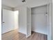 Bedroom closet with bifold doors, rod and shelf for storage, and light wood-look floors at 746 Masterpiece Dr, Sun City Center, FL 33573