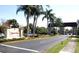 Community entrance featuring the 'Kings Point' sign, lush landscaping, and a secure gatehouse at 746 Masterpiece Dr, Sun City Center, FL 33573