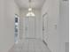 Inviting foyer featuring tiled flooring and a decorative pendant light at 746 Masterpiece Dr, Sun City Center, FL 33573
