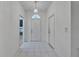 Entryway features tiled floor, centered front door with sidelight, and decorative pendant light at 746 Masterpiece Dr, Sun City Center, FL 33573