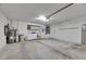 Spacious garage area featuring laundry, water heater, and access to other utilities at 746 Masterpiece Dr, Sun City Center, FL 33573
