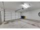 Spacious garage with a clean concrete floor, garage door, and ample room for storage at 746 Masterpiece Dr, Sun City Center, FL 33573