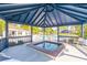 A sheltered hot tub is next to a community pool, surrounded by chairs and landscaping at 746 Masterpiece Dr, Sun City Center, FL 33573
