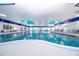 Large, bright indoor swimming pool with ample deck space and seating areas at 746 Masterpiece Dr, Sun City Center, FL 33573