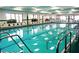 Bright indoor swimming pool area with multiple lanes and clear water at 746 Masterpiece Dr, Sun City Center, FL 33573