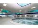 Well-lit indoor spa area featuring a hot tub and lounging space for relaxation at 746 Masterpiece Dr, Sun City Center, FL 33573