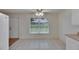 Bright kitchen area with tile flooring, ceiling fan, and view to the backyard at 746 Masterpiece Dr, Sun City Center, FL 33573