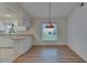 Bright kitchen and dining area with hardwood floors and backyard view at 746 Masterpiece Dr, Sun City Center, FL 33573