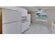 Spacious kitchen featuring white cabinets, appliances, and tile flooring at 746 Masterpiece Dr, Sun City Center, FL 33573