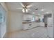 Bright kitchen features white appliances and tile floor at 746 Masterpiece Dr, Sun City Center, FL 33573