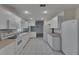 Eat-in kitchen with white appliances and tile floor at 746 Masterpiece Dr, Sun City Center, FL 33573
