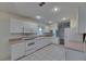 Bright kitchen featuring tiled flooring and white cabinetry and appliances at 746 Masterpiece Dr, Sun City Center, FL 33573