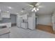Kitchen with tile flooring, white appliances and cabinetry, and ceiling fan at 746 Masterpiece Dr, Sun City Center, FL 33573
