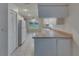 Open kitchen area with white appliances, tile flooring, and backyard view at 746 Masterpiece Dr, Sun City Center, FL 33573