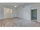 Inviting living room with light-colored laminate flooring and modern fixtures creating a seamless flow to other rooms at 746 Masterpiece Dr, Sun City Center, FL 33573