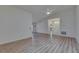 Bright and airy living room with vaulted ceiling, laminate floors, and access to other rooms in the house at 746 Masterpiece Dr, Sun City Center, FL 33573