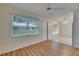 Bright living room features wood flooring, ceiling fan and natural light at 746 Masterpiece Dr, Sun City Center, FL 33573