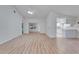 Bright, open living room with vaulted ceilings, ceiling fan, and attractive wood-look flooring at 746 Masterpiece Dr, Sun City Center, FL 33573