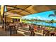 Scenic outdoor seating area overlooking a lake with lush landscaping and palm trees at 746 Masterpiece Dr, Sun City Center, FL 33573