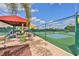 Outdoor pickleball courts featuring shade and seating for relaxing and socializing at 746 Masterpiece Dr, Sun City Center, FL 33573