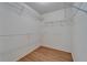 Walk-in closet with wood-look floors and wire shelving for storage at 746 Masterpiece Dr, Sun City Center, FL 33573