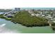 Beautiful coastal property featuring a lush green space and waterfront access at 819 Gulf Blvd, Indian Rocks Beach, FL 33785