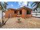 This home features a peaceful outdoor space with a charming fountain and stainless steel grill, perfect for entertaining at 819 Gulf Blvd, Indian Rocks Beach, FL 33785