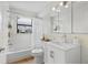 Bathroom features white tile, shower-tub combo, and a modern sink at 819 Gulf Blvd, Indian Rocks Beach, FL 33785