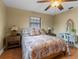 Comfortable bedroom features warm colored walls, ceiling fan, and floral bedding at 819 Gulf Blvd, Indian Rocks Beach, FL 33785