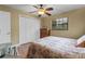 Bedroom features a ceiling fan, closet with white louvered doors, and a window at 819 Gulf Blvd, Indian Rocks Beach, FL 33785
