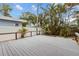 A spacious outdoor deck surrounded by a white fence and beautiful landscaping at 819 Gulf Blvd, Indian Rocks Beach, FL 33785