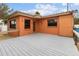 Orange house exterior with a grey wood deck and tiled roof at 819 Gulf Blvd, Indian Rocks Beach, FL 33785