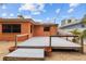 Exterior view of deck, orange house, and gravel landscaping at 819 Gulf Blvd, Indian Rocks Beach, FL 33785