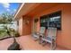 Relaxing front porch with rocking chairs, offering a cozy and inviting entrance to the home at 819 Gulf Blvd, Indian Rocks Beach, FL 33785