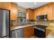 Updated kitchen boasts stainless steel appliances, granite countertops, and natural lighting at 819 Gulf Blvd, Indian Rocks Beach, FL 33785