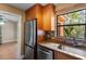 Well-equipped kitchen with stainless steel appliances, granite countertops, and a large window at 819 Gulf Blvd, Indian Rocks Beach, FL 33785