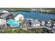 Aerial view of waterfront restaurant with outdoor seating and boat docks on a sunny day, with blue umbrellas offering shade at 819 Gulf Blvd, Indian Rocks Beach, FL 33785