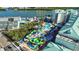 Aerial view of a vibrant waterpark featuring colorful slides, winding pools, and lush landscaping, surrounded by resort buildings at 819 Gulf Blvd, Indian Rocks Beach, FL 33785