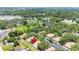 Expansive aerial view of the property surrounded by lush trees, a lake, and other well-maintained buildings at 8436 60Th N St # 304, Pinellas Park, FL 33781