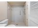 Accessible bathroom featuring a tiled walk-in shower with grab bars and white fixtures at 8436 60Th N St # 304, Pinellas Park, FL 33781
