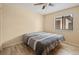 Neutral bedroom with a queen bed, window with blinds, and light wood-look flooring at 8436 60Th N St # 304, Pinellas Park, FL 33781