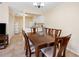 Cozy dining room with wooden table set, view into the kitchen, and neutral color palette at 8436 60Th N St # 304, Pinellas Park, FL 33781